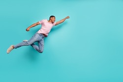 Full Length Photo Of Strong Hurrying Guy Wear Pink T-shirt Jumping High Flying Help Empty Space Isolated Teal Color Background