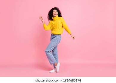 Full length photo of sweet shiny curly woman wear yellow pullover dancing isolated pink color background - Powered by Shutterstock