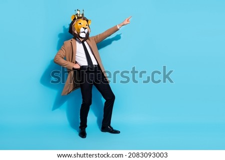 Full length photo of weird absurd cool guy dance mardi gras occasion point finger empty space isolated over blue color background