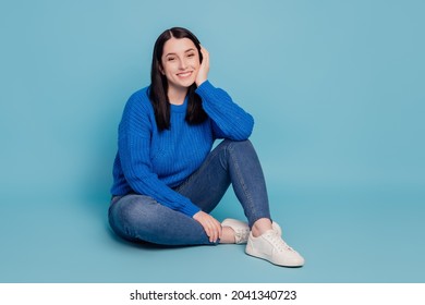 Full length photo of young attractive lovely pretty girl sitting on floor dream isolated over blue color background - Shutterstock ID 2041340723