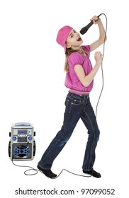 Full Length Photo Of Young Girl Singing Into Microphone With Karaoke Machine In Background, Isolated On White.