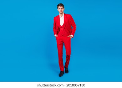 Full length photo of young handsome business man serious confident hands in pocket wear suit isolated over blue color background