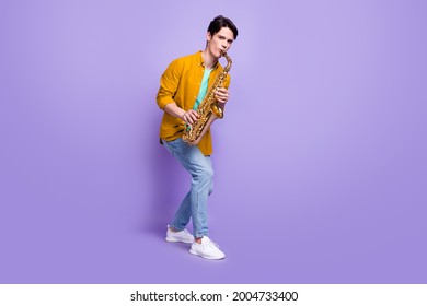 Full Length Photo Of Young Man Happy Positive Smile Play Sax Jazz Artist Isolated Over Violet Color Background