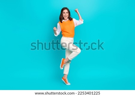 Full length photo of young successful business agent woman fists up celebrate much extra money payment isolated on aquamarine color background