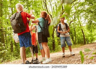 Full length picture of boy with prosthetic leg playing games with friends at forest - Powered by Shutterstock