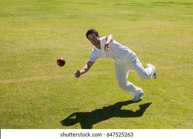 Full length of player catching ball on field during sunny day - Powered by Shutterstock