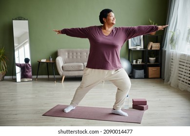 Full Length Portrait Of Active Senior Woman Doing Yoga At Home And Enjoying Workout Indoors, Copy Space