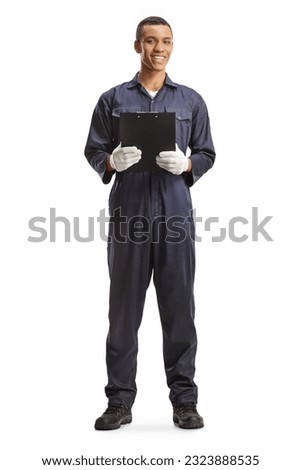 Full length portrait of an african american car mechanic holding a clipboard and smiling isolated on white background