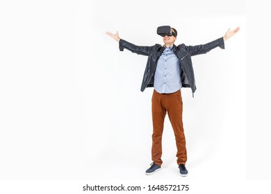 Full Length Portrait Of An Amazed Guy Using A Virtual Reality Headset Isolated On White Background