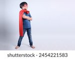 Full Length Portrait of Asian Boy Wearing Superhero Costume Confidently Isolated on Gray Background