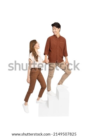 Full length portrait of Asian couple walking go up stairs isolated on white background