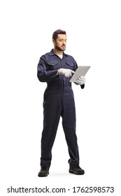 Full length portrait of an auto mechanic using a tablet isolated on white background