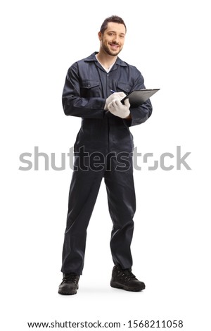 Full length portrait of an automechanic standing with a clipboard isolated on white background