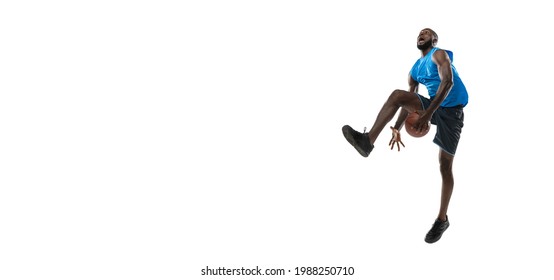 Full Length Portrait Of A Basketball Player With A Ball Isolated On White Studio Background. Advertising Concept. Fit African American Athlete Jumping With Ball. Motion, Activity, Movement Concepts.