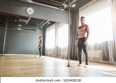 Full Length Portrait Of Bearded Male Spending Time In Front Of Mirror In The Class Of Pole Dance