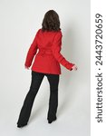 full length portrait of beautiful brunette woman model, wearing red trench coat jacket leather pants. standing pose in backview, walking away the camera. isolated silhouette on white studio background