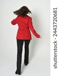 full length portrait of beautiful brunette woman model, wearing red trench coat jacket leather pants. standing pose in backview, walking away the camera. isolated silhouette on white studio background