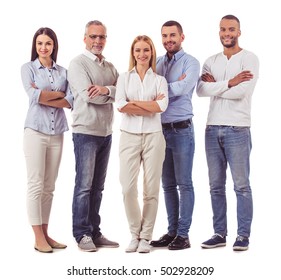 Full Length Portrait Of Beautiful Business People In Smart Casual Wear Looking At Camera And Smiling While Standing With Folded Arms On A White Background