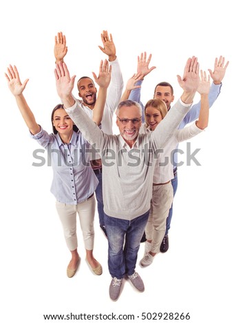 Full length portrait of beautiful business people in smart casual wear raising their hands, looking at camera and smiling, isolated on white
