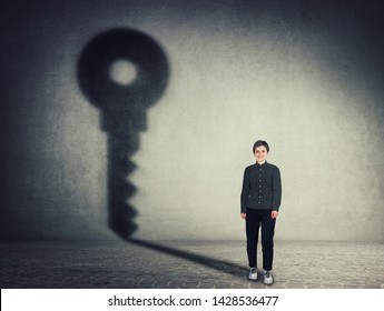 Full Length Portrait Of Beautiful Businesswoman, Casting A Key Shadow On The Wall. Ambition And Business Success Concept. Motivation And Inner Strength Symbol.