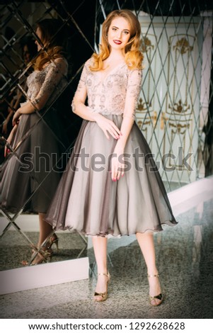 A full length portrait of a beautiful elegant woman in the evening dress. Fashion, evening dresses for events.