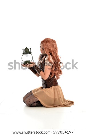 full length portrait of a beautiful girl wearing steampunk outfit, kneeling pose isolated on white background.
