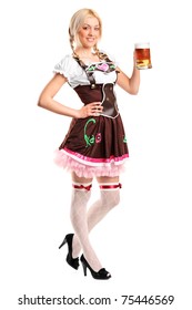 A full length portrait of a beautiful woman wearing a traditional costume holding a beer glass isolated on white