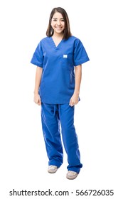 Full length portrait of a beautiful young Hispanic nurse wearing scrubs in a white background