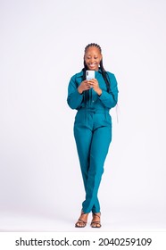 Full Length Portrait Of A Black African Young Business Woman With A Cell Phone Standing Over White Background Excited