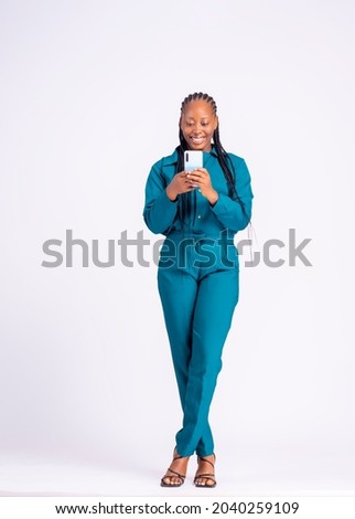 Image, Stock Photo Young black female standing in studio against yellow and blue lights