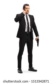 Full Length Portrait Of A Bodyguard With A Gun Isolated On White Background