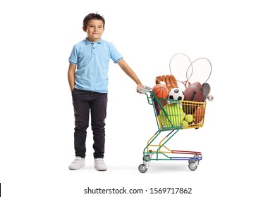 Full length portrait of a boy with a soccer ball, rugby ball, tennis ball and a basketball in a shoping cart isolated on white background - Powered by Shutterstock