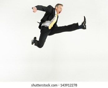 Full length portrait of a businessman jumping against white background