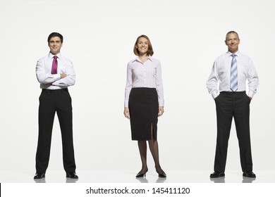 Full Length Portrait Of Businesspeople Standing Side By Side Against White Background