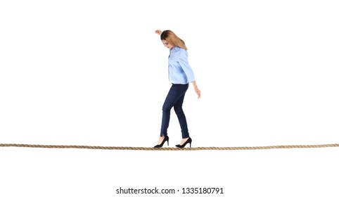 Full length portrait of businesswoman balancing on rope against white background