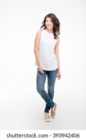 Full Length Portrait Of A Casual Happy Woman Standing Isolated On A White Background