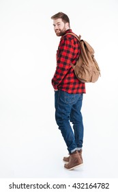 Full Length Portrait Of A Casual Man Looking Back At Camera Isolated On A White Background