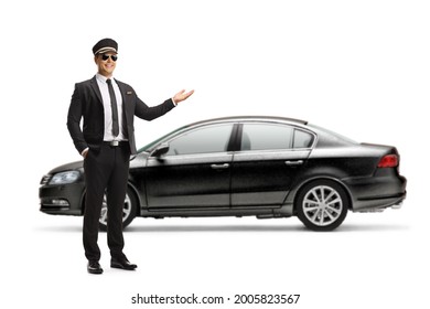 Full Length Portrait Of A Chauffeur Showing A Black Car Isolated On White Background