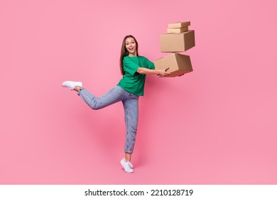 Full length portrait of cheerful crazy person arms hold pile stack packages isolated on pink color background