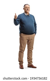 Full length portrait of a cheerful mature man gesturing a thumb up sign isolated on white background