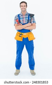 Full length portrait of confident plumber holding monkey wrench and plunger over white background