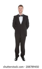 Full Length Portrait Of Confident Waiter Standing Hands Behind Back Over White Background