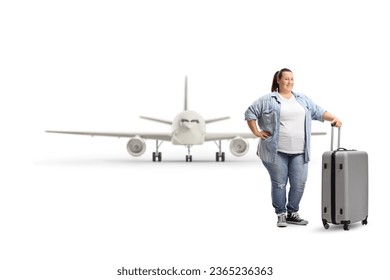 Full length portrait of a corpuelnt young woman with a suitcase in front of an airplane isolated on white background - Shutterstock ID 2365236363