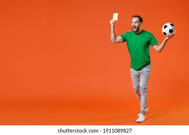 Full length portrait crazy young man football fan in green t-shirt support favorite team with soccer ball propose player retire from field isolated on orange background. People sport leisure concept - Powered by Shutterstock