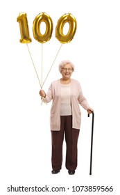 Full Length Portrait Of An Elderly Woman With A Golden Number Hundred Balloon And A Cane Isolated On White Background