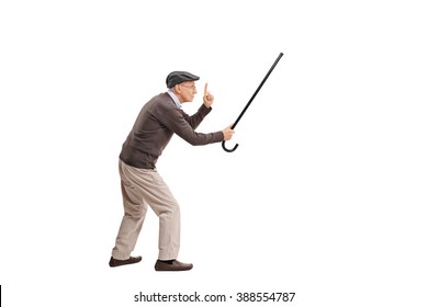 Full length portrait of an enraged senior man holding his cane as a sword and threatening someone isolated on white background
