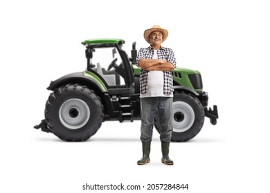 Full Length Portrait Of A Farmer Standing In Front Of A Green Tractor Isolated On White Background