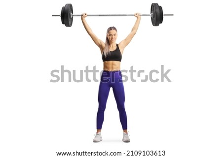 Full length portrait of a female bodybuilder standing and lifting weights isolated on white background