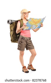 Full Length Portrait Of Female Hiker Looking At Map Isolated On White Background