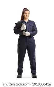 Full length portrait of a female mechanic in a uniform standing and looking at camera isolated on white background